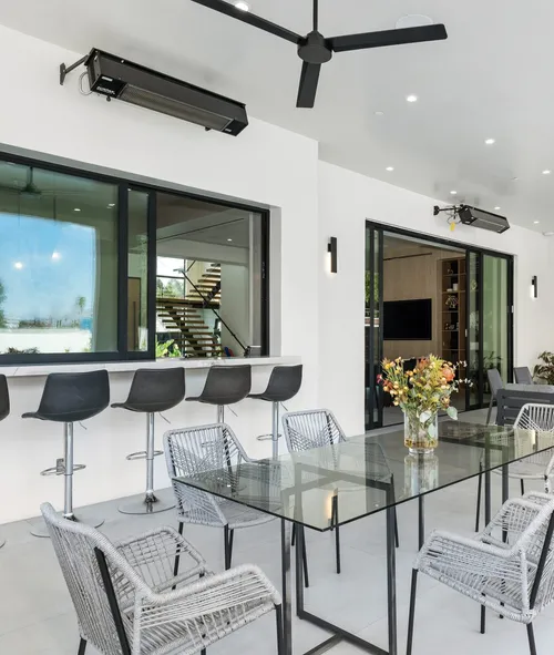 Modern dining and bar area with Aluminum Series Horizontal Sliding Windows and large glass patio doors in a contemporary home.